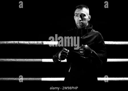 Mixed martial artist stands with his hands up. Concept of mma, ufc, thai boxing, classic boxing. Mixed media Stock Photo