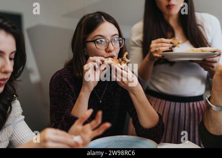 Diverse business group enjoying pizza, taking a break and refueling for continued success. Stock Photo