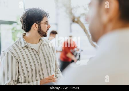 A group of business colleagues discussing and strategizing, sharing ideas and working together in a multi-generational and multi-ethnic workplace Stock Photo