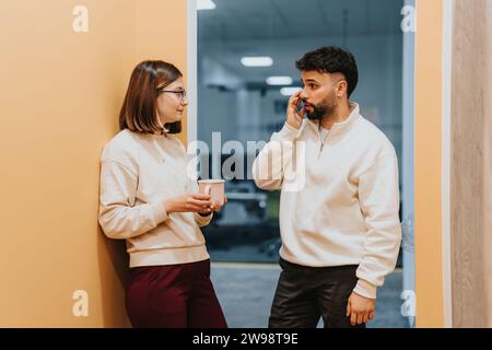 Male and female colleagues collaborating on business growth strategies in office. Stock Photo