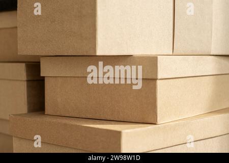 Kraft boxes, stacked paper sealed packages. Stack parcel in warehouse. Product packaging. Stock Photo