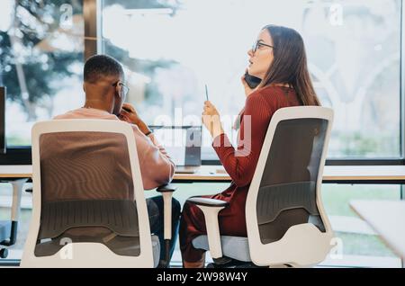 Multiethnic team works together on a project, conducting market analysis and financial planning. Stock Photo