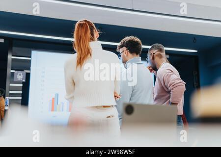 Collaborative brainstorming session with successful young entrepreneurs discussing market analysis and strategizing for business expansion. Stock Photo