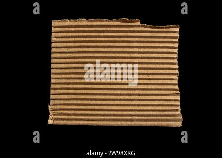Ripped paper piece isolated on black background. Torn paper with copy space. Stock Photo