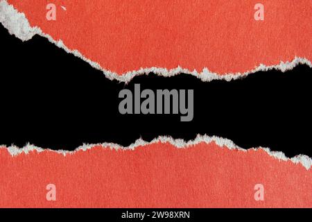 Ripped paper piece isolated on black background. Torn paper with copy space. Stock Photo