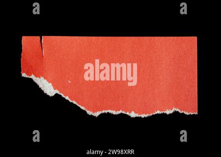 Ripped paper piece isolated on black background. Torn paper with copy space. Stock Photo