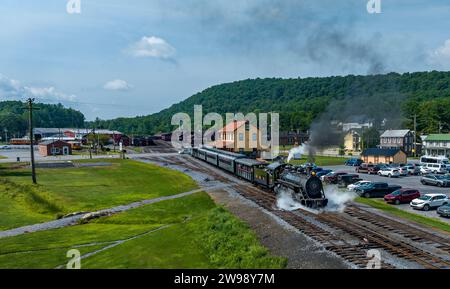 An Aerial View of a Narrow Gauge Steam Passenger Train, Leaving the Station for a Days Work, on a Sunny Summer Day Stock Photo