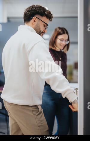Business professionals in a modern kitchen, enjoying a pleasant atmosphere while having a conversation over coffee and tea. Stock Photo