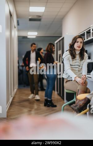 Coworkers in a modern kitchen discussing and brainstorming ideas. Enjoying a positive atmosphere of collaboration while drinking coffee and tea. Stock Photo