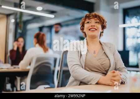 Successful businesswoman celebrating achievements in the office Stock Photo