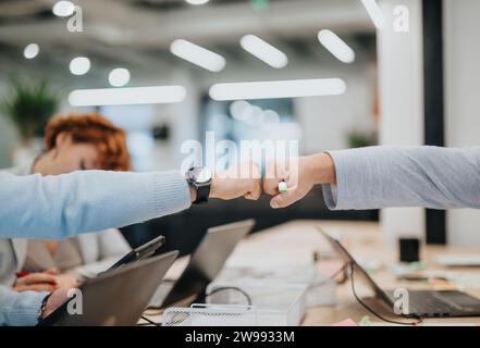 Men giving fist bump. Fist bump concept. Bumping fists. Teamwork concept. Success concept. Coworkers giving fist bump. Respect concept. Stock Photo