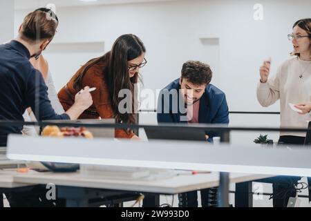 Diverse group of professionals collaborating on business growth, analyzing reports, and meeting project deadlines in a dynamic corporate environment. Stock Photo