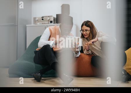 Colleagues collaborating on a project deadline in a corporate team. Stock Photo