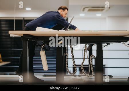 Employee working alone at the office late at night. He is catching up the deadline project. Stock Photo