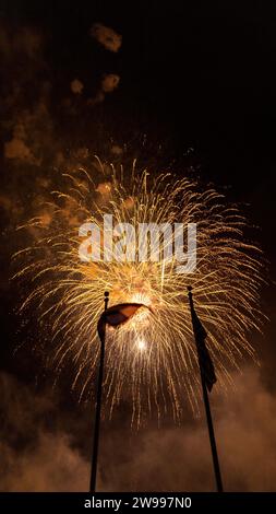 A stunning and vibrant night sky illuminated American flag with fireworks Stock Photo