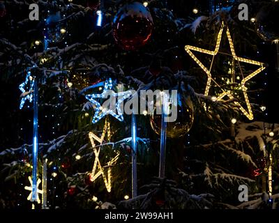 A Christmas tree adorned with festive lights and ornaments Stock Photo