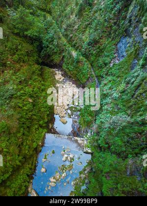 A tranquil landscape featuring a body of water surrounded by lush greenery. Madeira, Portugal Stock Photo