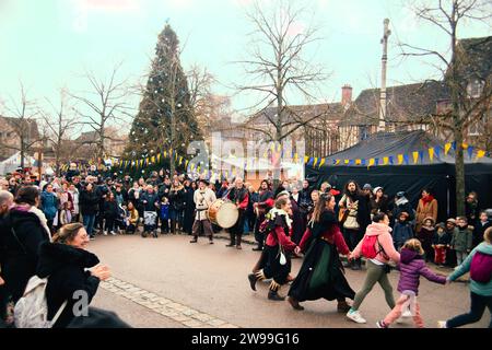 A diverse group of people enjoy a lively festival together in front of a large audience Stock Photo