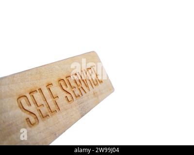 Self service text sign on wooden label Stock Photo