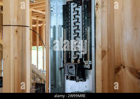 An electrical power control panel switch box mounted for circuit breaker at wooden frame beams on wall Stock Photo