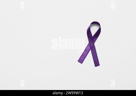 Purple ribbon on grey background. Cancer awareness concept Stock Photo