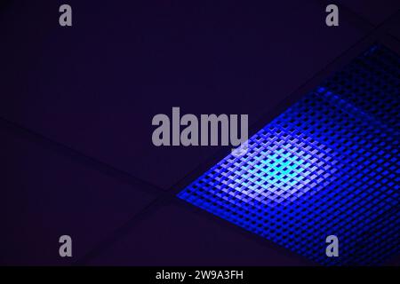 Blue spot of stage illumination is on a ceiling Stock Photo