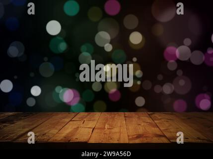 Empty top of wooden table with a sparkling bokeh of colorful party lights in the background. For product display and advertising and promotional purpo Stock Photo
