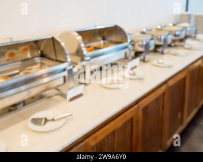 Many buffet heated trays in the hotel restaurant blur background Stock Photo