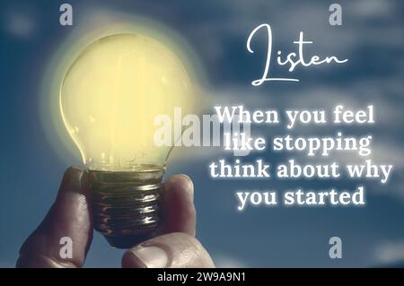 Motivational quote about when you feel like stopping with closeup light bulb background Stock Photo