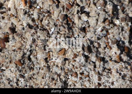 An ancient piece of cement from the bottom of the ocean that glued together many small pebbles of pebbles Stock Photo