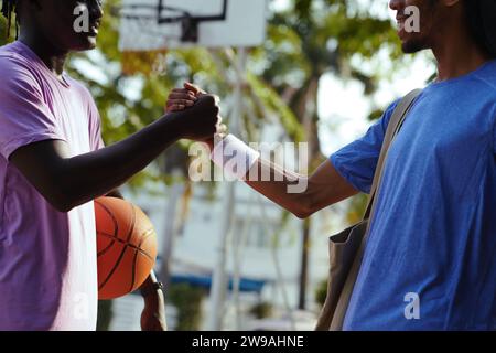 Basketball players giving each other strong handshake after good game Stock Photo