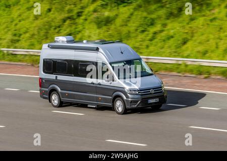 2021 Indium Grey Metallic two-tone VW Volkswagen Grand California TDi 4Motion A Tdi 1968cc Diesel Automatic van; travelling at speed on the M6 motorway in Greater Manchester, UK Stock Photo