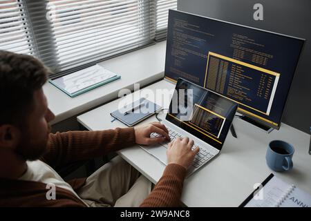 High angle closeup of adult man coding at office workplace working in IT development, copy space Stock Photo
