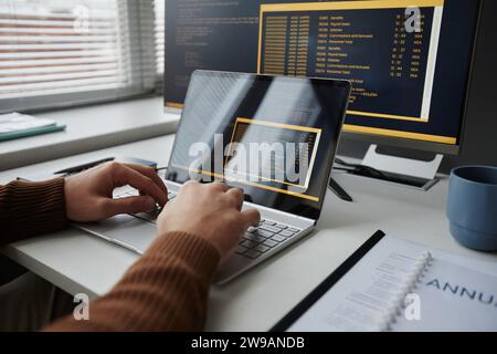 Close up of male hands typing at laptop keyboard and writing code in IT development office, copy space Stock Photo