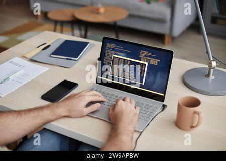 Closeup of unrecognizable man typing at computer keyboard and writing code at home office workplace, copy space Stock Photo