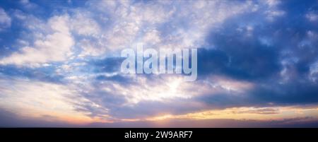 Beautiful sunset sky with clouds and bright sunlight. Background. Stock Photo