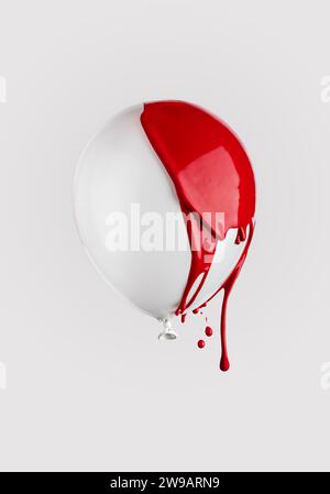 Red paint drips on a white balloon floating in the air. Minimalistic trendy concept. Stock Photo