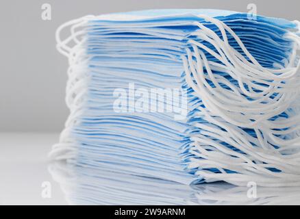 Large stack of medical disposable face masks close-up. Coronavirus protection concept. Stock Photo