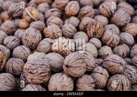 Top down view, whole walnuts displayed on street food market. Stock Photo