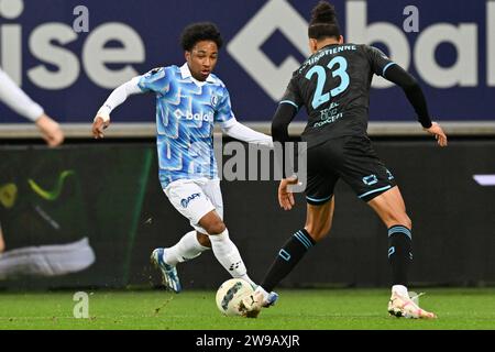 Malick Fofana (19) of AA Gent pictured in action with Joel Schingtienne (23) of OHL during the Jupiler Pro League season 2023 - 2024 match day 19 between AA Gent and Oud Heverlee Leuven on December 21 , 2023 in Gent, Belgium. (Photo by David Catry / Isosport) Stock Photo