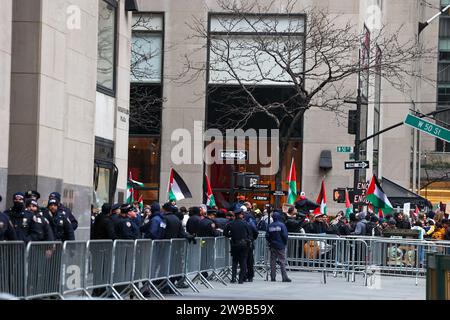 New York, United States. 25th Dec, 2023. December 25, 2023, New York City, NY. Thousands of Pro Palestine protesters ascended upon popular tourist destinations at Christmas in New York City to cancel Christmas. Protesters marched down 5th Avenue near favorite department store window displays. Larger groups protested in front of Rockefeller Plaza. Visitors could not get close to the coveted Rockefeller Tree. Ice skating was shut down amiss the large crowd. NYPD officers were in full force. (Photo by Robyn Stevens Brody/Sipa USA) Credit: Sipa USA/Alamy Live News Stock Photo