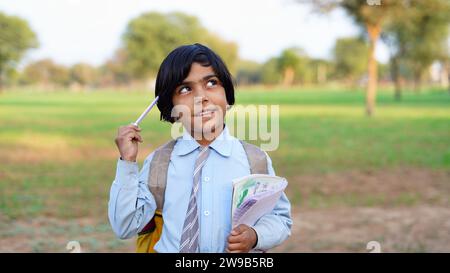 Kid, smile and portrait of student with books for education, study or learning isolated on a green field background. Stock Photo