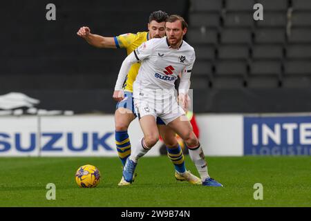 Milton Keynes Dons Alex Gilbey is challenged by Colchester United's captain Connor Hall during the first half of the Sky Bet League 2 match between MK Dons and Colchester United at Stadium MK, Milton Keynes on Tuesday 26th December 2023. (Photo: John Cripps | MI News) Credit: MI News & Sport /Alamy Live News Stock Photo