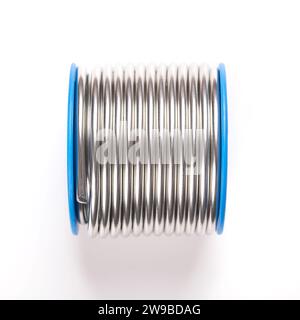 Spool of soft solder wire, with a diameter of 3 millimeters. Fittingslot, fusible metal alloy of tin and copper, used to create a permanent bond. Stock Photo