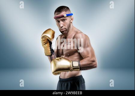 Portrait of a professional Thai boxer. Muay Thai, kickboxing, martial arts concept. Mixed media Stock Photo