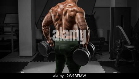 rear view of male bodybuilder posing in gym Stock Photo - Alamy