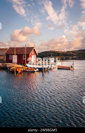 Sunrise over the colourful wooden houses in the harbour of Björholmen on the island of Tjörn in the archipelago of the west coast of Sweden Stock Photo