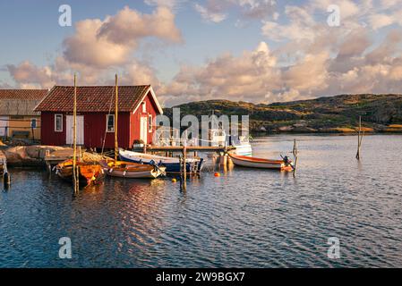 Sunrise over the colourful wooden houses in the harbour of Björholmen on the island of Tjörn in the archipelago of the west coast of Sweden Stock Photo