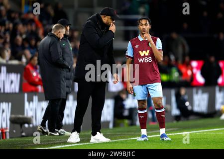 Burnley manager Vincent Kompany (left) speaks with player Wilson Odobert during the Premier League match at Turf Moor, Burnley. Picture date: Tuesday December 26, 2023. Stock Photo