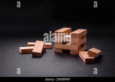 Wooden blocks of Jenga game as a concept idea of risk in achieving a goal. Background for your idea Stock Photo